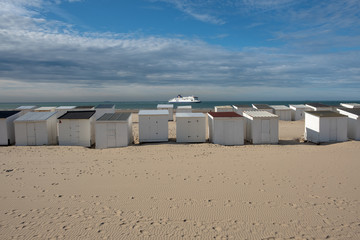 Obraz premium White wooden cabins on the beach in France
