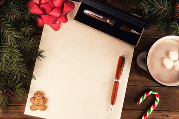 Writing a letter to Santa Claus, directly above. Flat lay for Christmas concept.