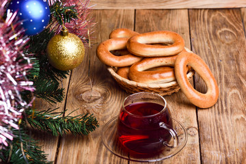 Hot tea with bagels on a wooden background.