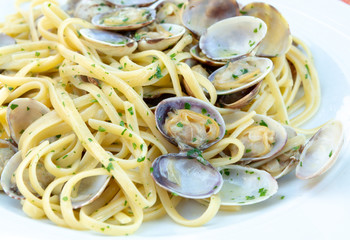 Traditional Italian seafood, spaghetti vongole made with seashells and linguini pasta