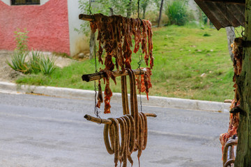 Original Caribbean food on the roadside in the Dominican Republic. Smoked pork, morcillas and...