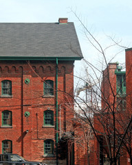Naklejka premium Old Brick Buildings with Crane in Background