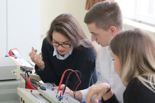Three young students in technical vocational training, the lesson in technical college.