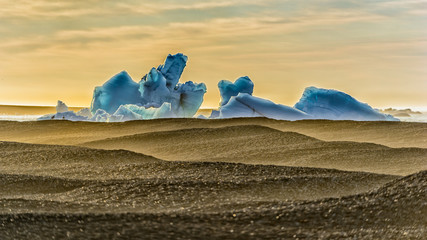 Norway Svalbard - Iceberg with sand wave foreground
