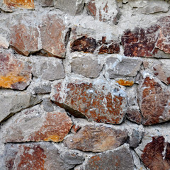 stone wall still under construction, mortar joints to be completed and stones need a final cleaning.