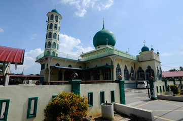 Exterior of Al-Athar Mosque in Bagan Serai, Perak, Malaysia. An old mosque was build in 1966. Has big green dome one tall minaret. 