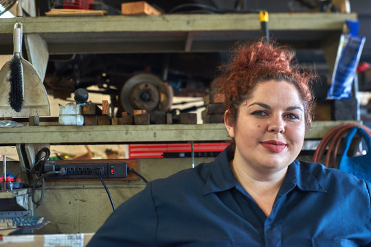 Female Mechanic Working on Cars in Her Shop