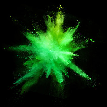 Explosion of coloured powder isolated on black background.