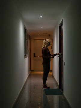 Girl entering apartment in modern house