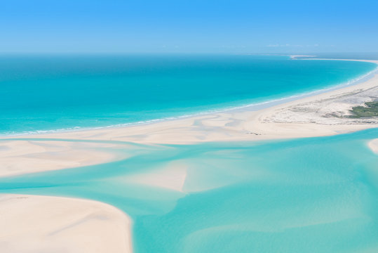 Aerial view of turquoise tidal flats waters