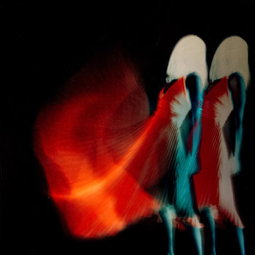 Creative movement of woman dancing in a glowing red dress