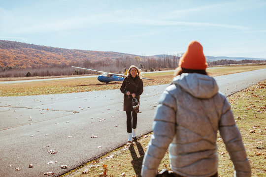 Friends gathered on airfield, taking turns flying gliders in upstate New York