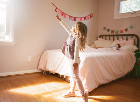 Little girl practicing ballet moves in her room