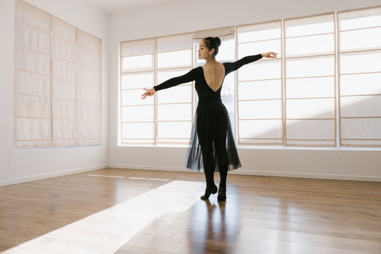 Young professional dancer practicing in a studio