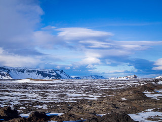Icelandic vulcano landscape with a snowy mountains top on horizonin in Leirhnjúkur, near the Krafla Vulcano, Iceland