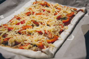Homemade pizza. Products from puff pastry. Cooking yourself. Healthy food. Vegetables, cheese, greens, chicken. Dough. Process of making pizza.