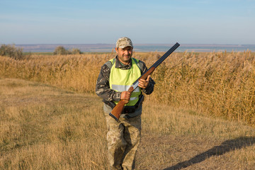 Hunters with a german drathaar and spaniel, pigeon hunting with dogs in reflective vests	