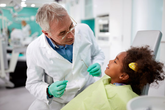 Dentist with child in dental practice