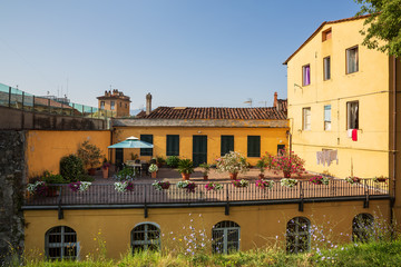 Naklejka na ściany i meble Rooftop garden terrace as seen from a walk around the walls encircling the beautiful city of Lucca in Tuscany, Italy