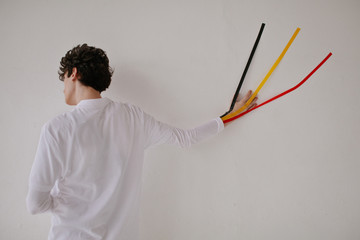 Man with taped hand to wall