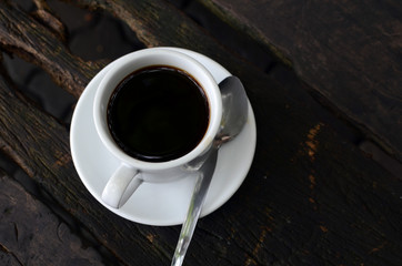 Cup Of Black Coffee on dead wood table
