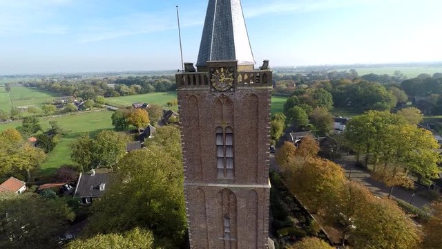 Drone flying away from church clock