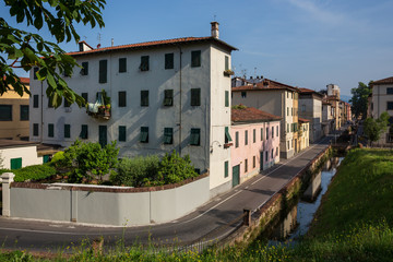 Fototapeta premium Beautiful buildings visible from the famous walls encircling the city of Lucca in Tuscany, Italy