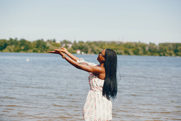 Black girl in a summer lake
