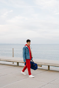 Man in red sportswear with bag
