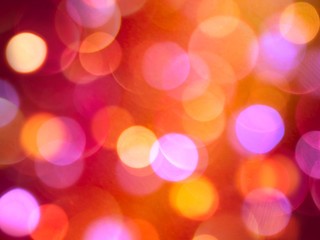 Bright glowing orange and purple glowing blurred light abstract celebration background