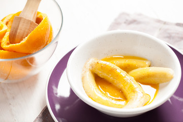 Fried bananas in orange sauce, a delicious dessert from fruits, butter and cognac.