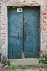 Blue door with the number 8 stenciled in red, found in Lucca Italy