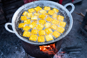 Fried tofu on traditional stove