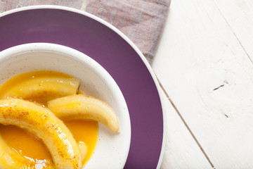 Fried bananas in orange sauce, a delicious dessert from fruits, butter and cognac.