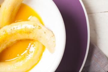 Fried bananas in orange sauce, a delicious dessert from fruits, butter and cognac.