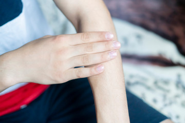 close up hand touch arm feeling pain f