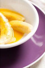 Fried bananas in orange sauce, a delicious dessert from fruits, butter and cognac.