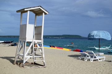 Laiya, San Juan, Batangas, Philippines - October 31, 2016: empty white lifeguard tower with cloudy sky in white sand beach