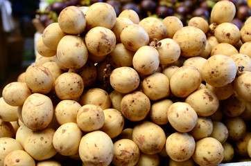 fresh lanzones fruit symmetrically to attrack buyers at market stall
