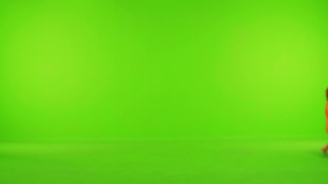 Cute little toddler walks happily from side to side, stops and eat.