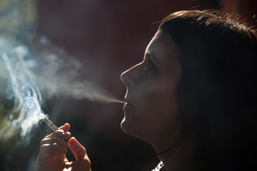Fototapeta premium woman smoking a cigarette - anti smoking campaign