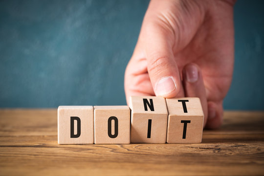 Hand turns two cubes, changing the word "don't" to "do it" 