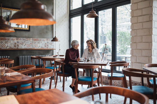 Girlfriends Chatting at Cafe