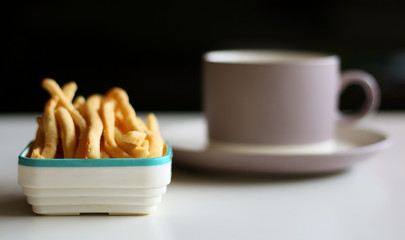 Cheese stick pastry and a cup of drink.