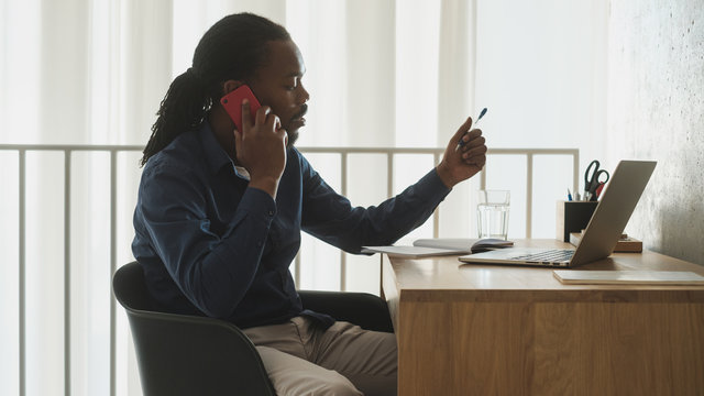 Young Businessman Using Phone At The Office