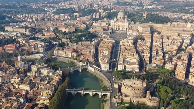 Aerial view of Rome, Castel Sant'Angelo (Castle of the Holy Angel) in foreground and Vatican City in background, bridges over river Tiber - cityscape of capital city of Italy from above, Europe
