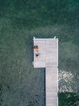 Woman cutting stone fruit on the dock