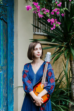 Young girl holding a ukulele