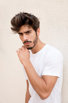 Portrait of a handsome young man with goatee looking at camera