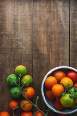 Fototapeta na wymiar Cherry tomato on wooden background